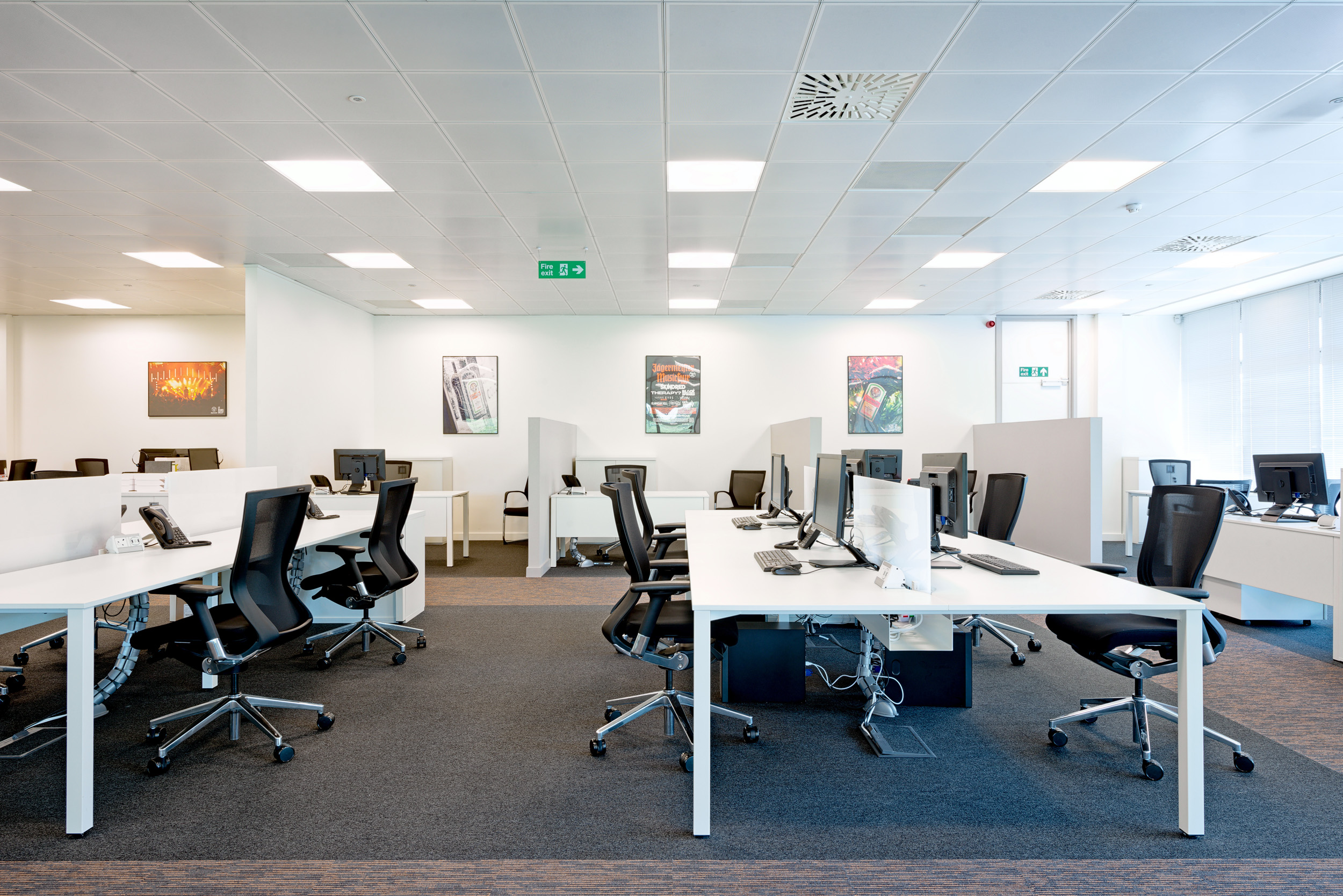Jagermeister Open-Plan Workspace white workspace with black office seats and minimal design