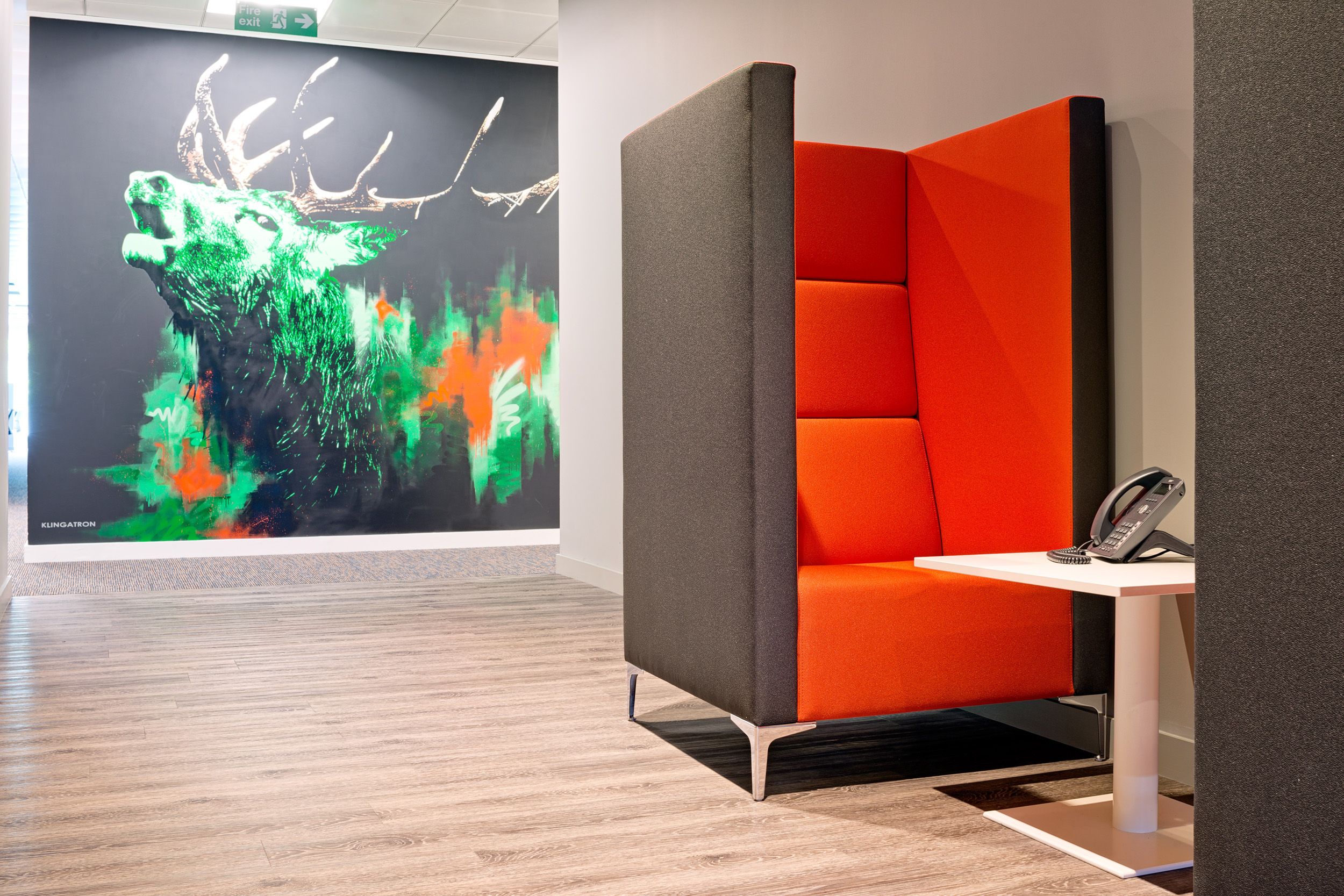 Jagermeister Quiet Area featuring a bright red acoustic seat with tall sides, promoting a quiet area with a bespoke designed wall as the backdrop