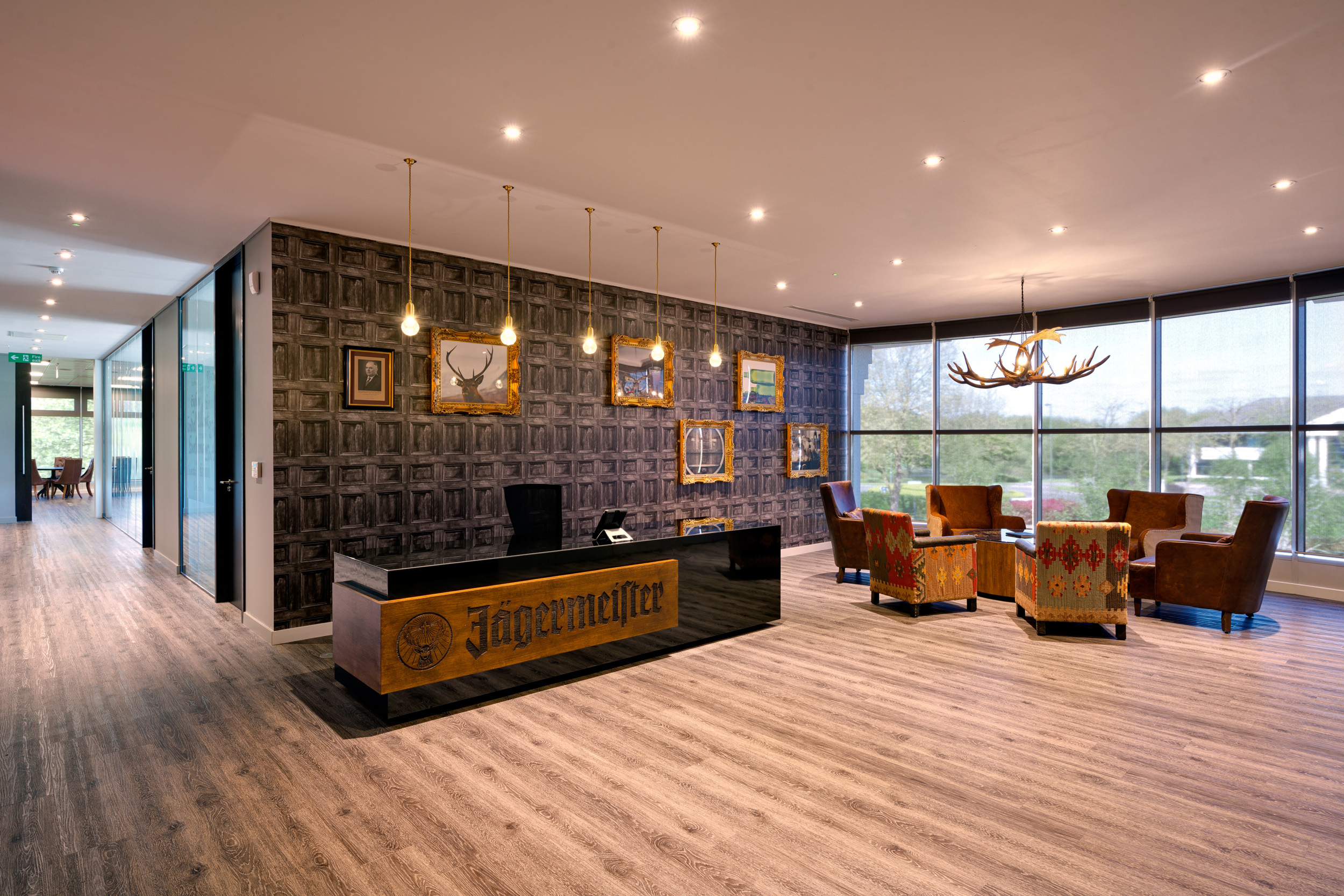 Jagermeister Reception Area Wide View at Jagermeister wider shot of the office. Glass view overlooking into the wooded location. Rustic charm runs throughout.