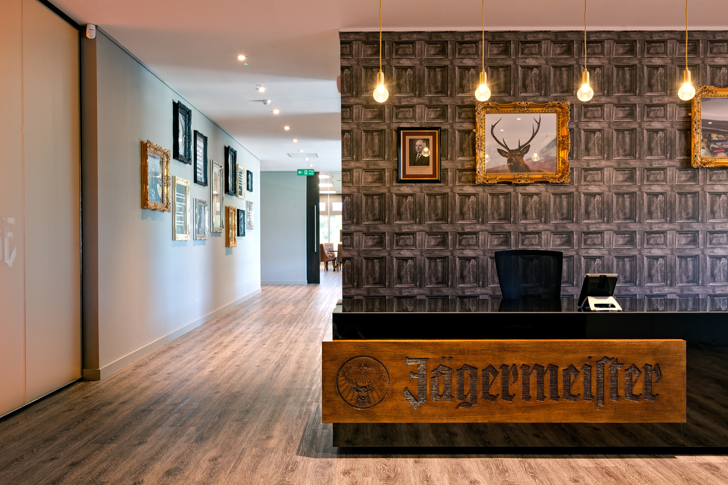 Jagermeister Reception Area Reception area at Jagermeister with a bespoke sign reading 'Jagermeister'. Images of stags framed with lighting and bespoke wallpaper