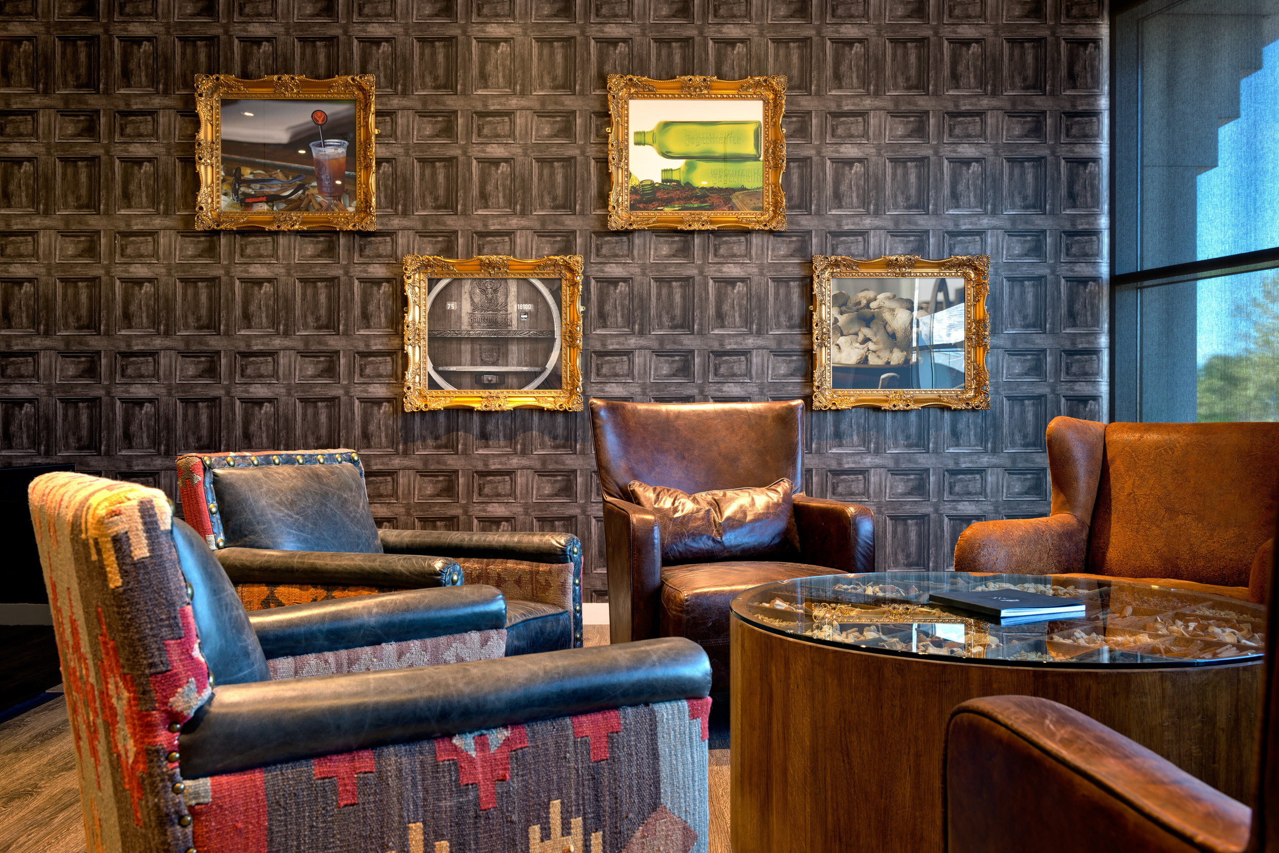 Jagermeister seating area with plush seats, black leather and wooden coffee tables