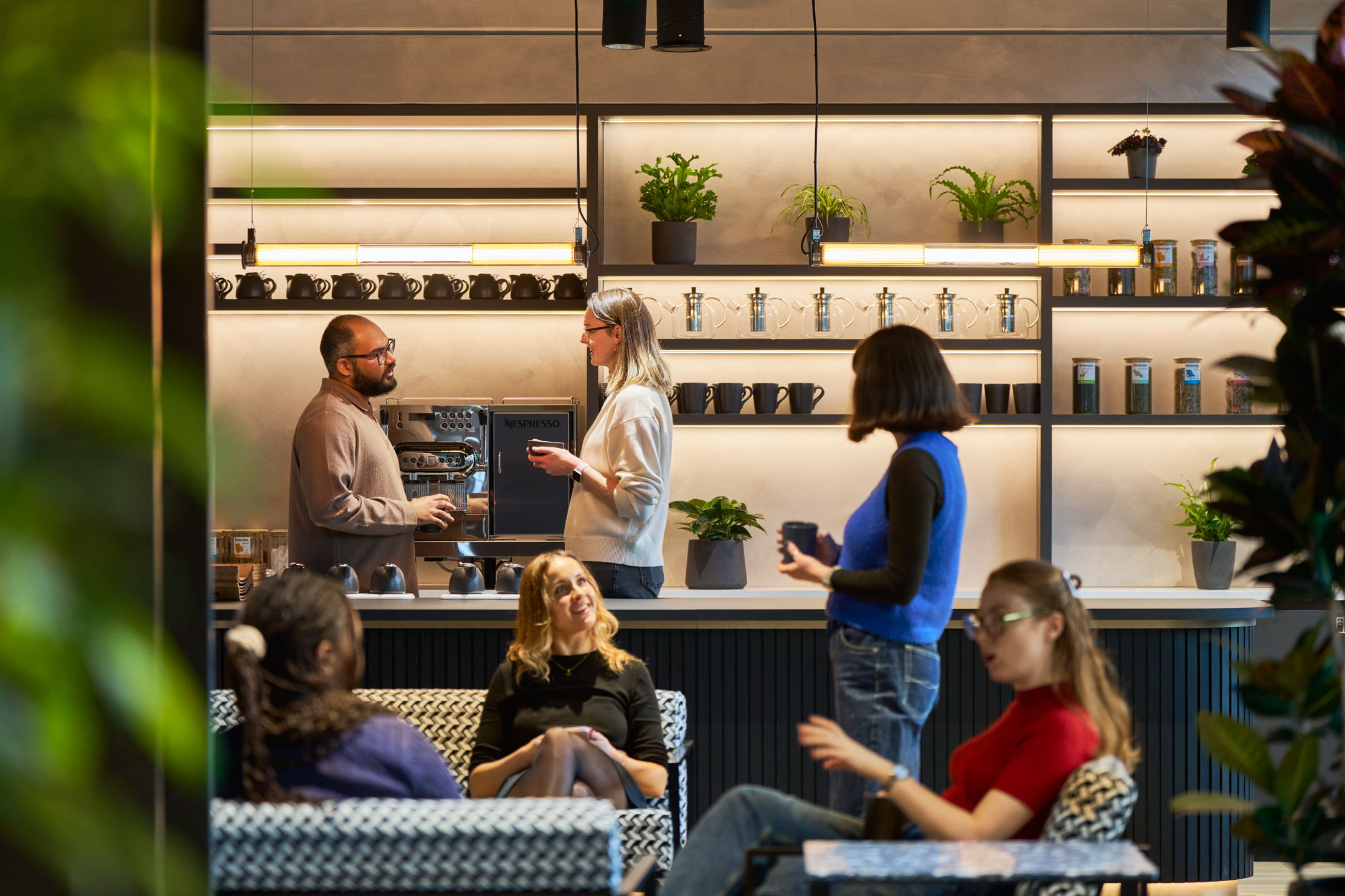 Entertainment Company Teapoint with Modus employees smiling drinking coffee.