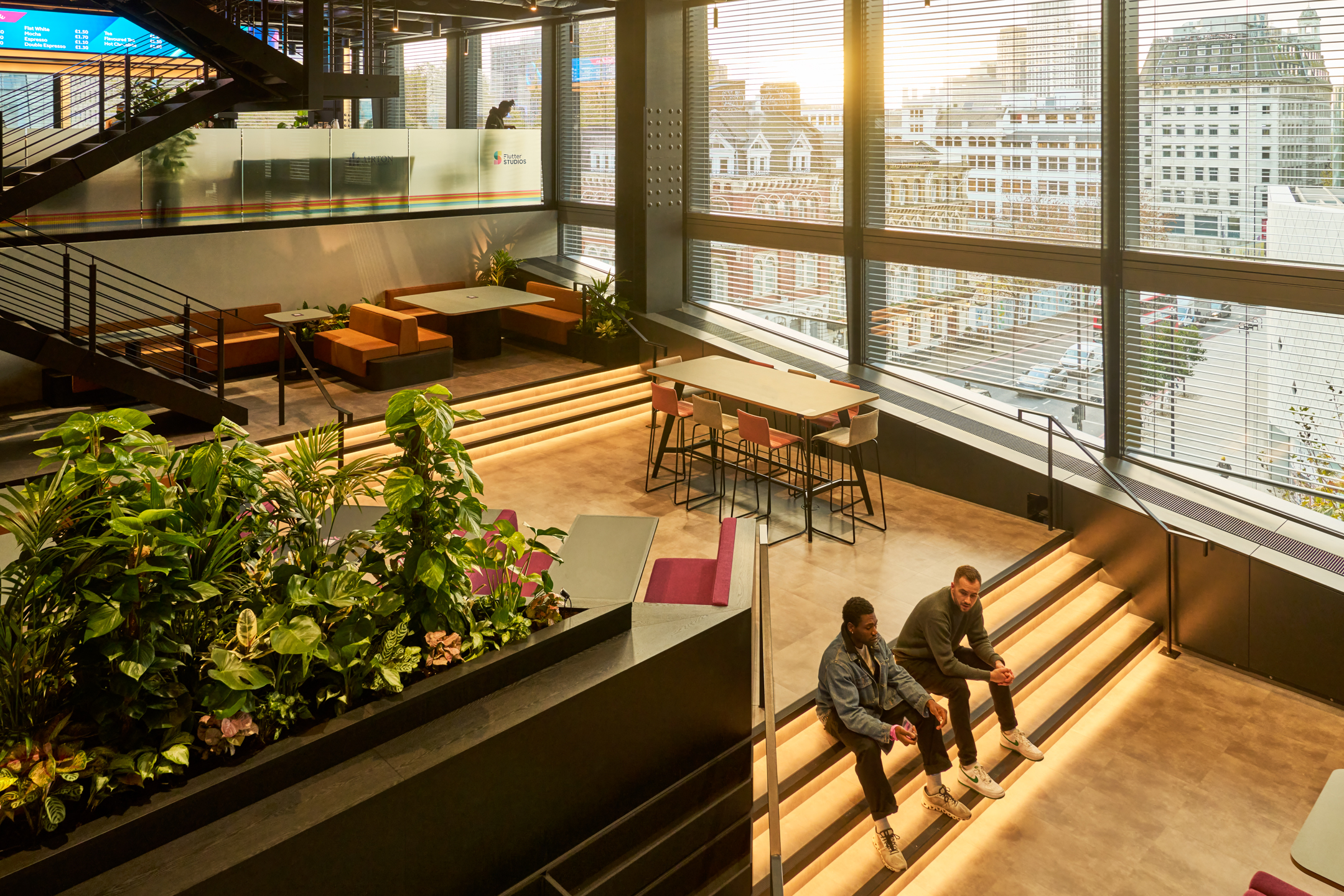 Gambling Company open-plan space with impressive views of the City of London, LED lighting and biophilic plants.