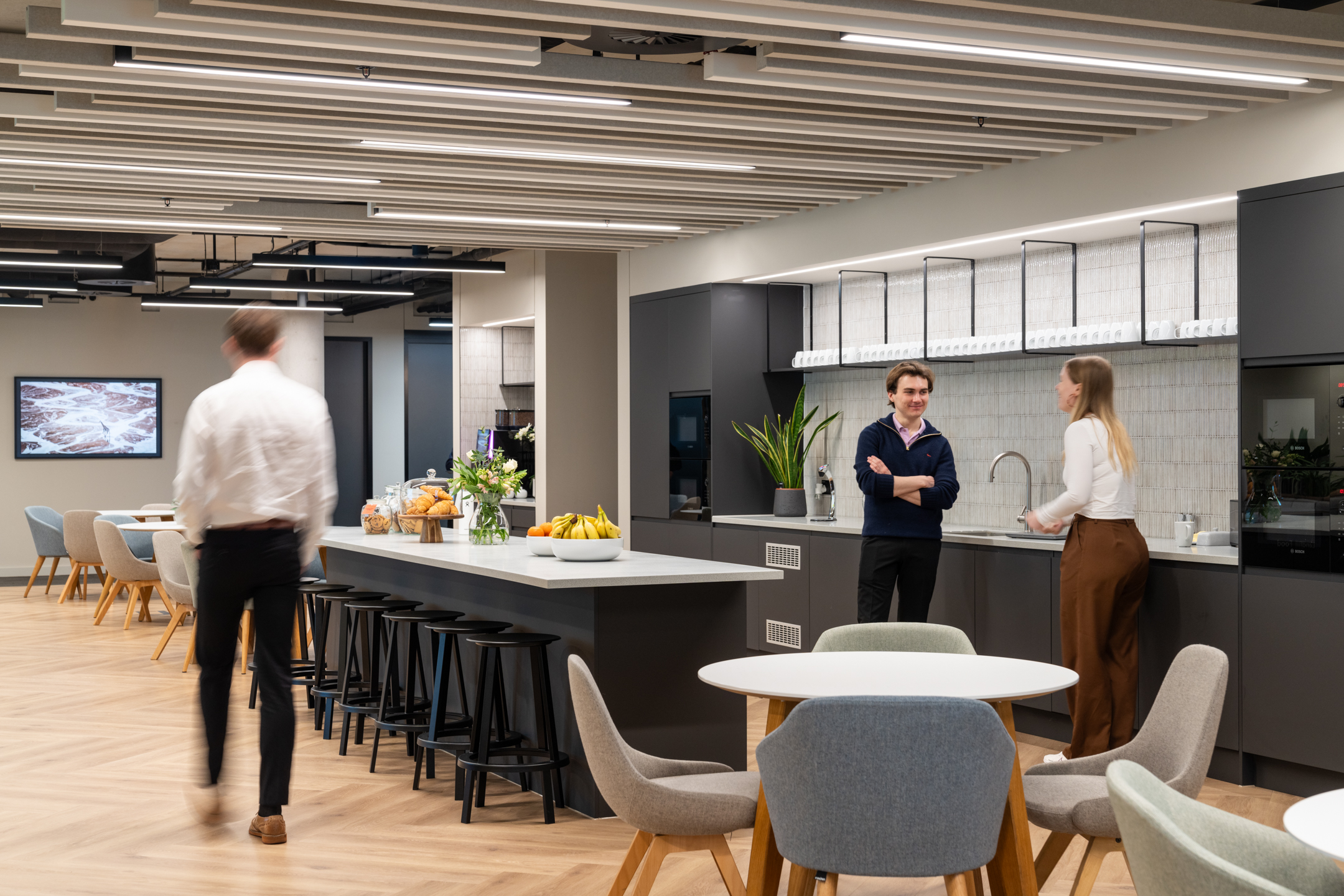 Costello Medical teapoint with grey furnishings, green plants and high bar stools.
