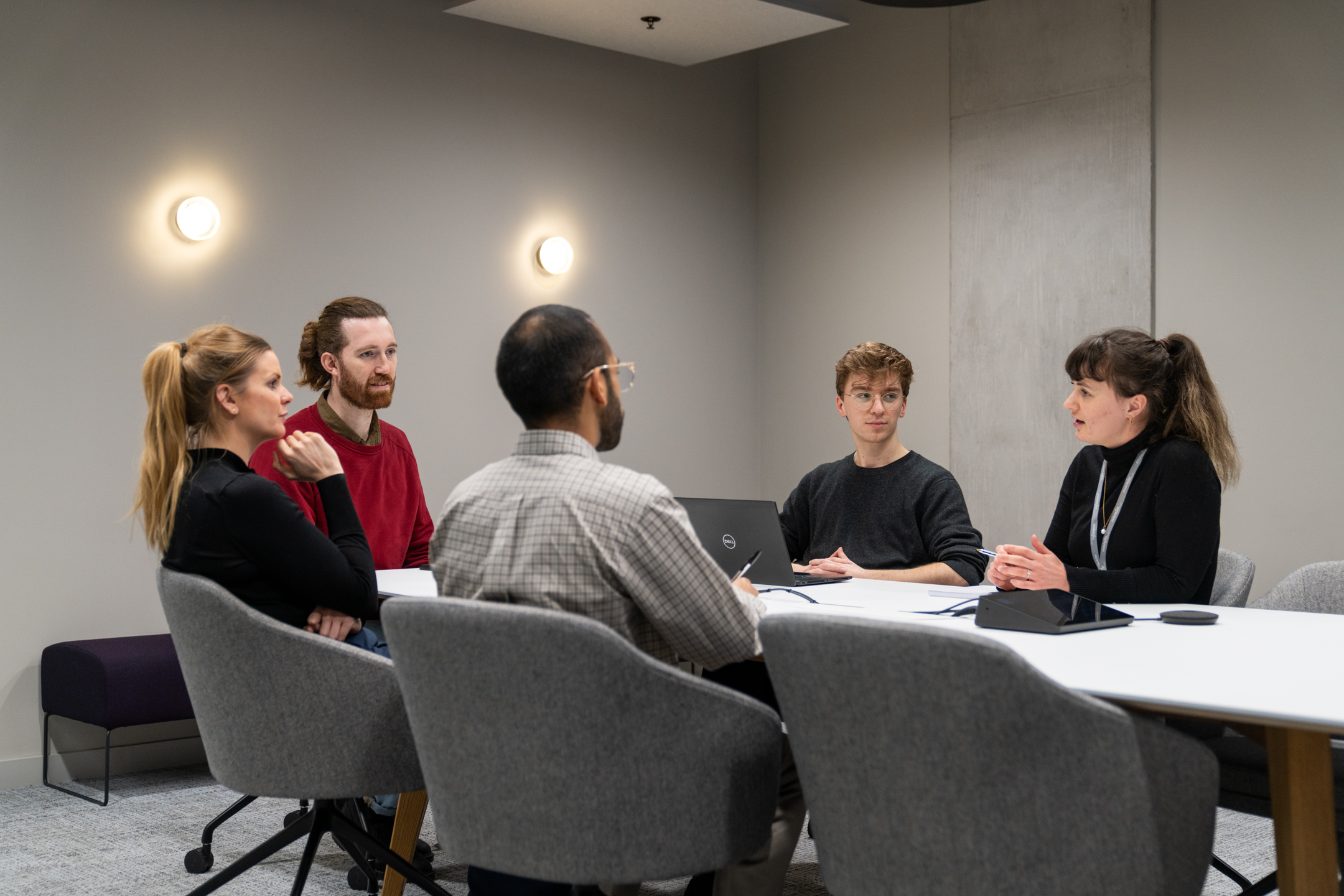 Costello Medical boardroom designed by Modus with employees in a meeting.
