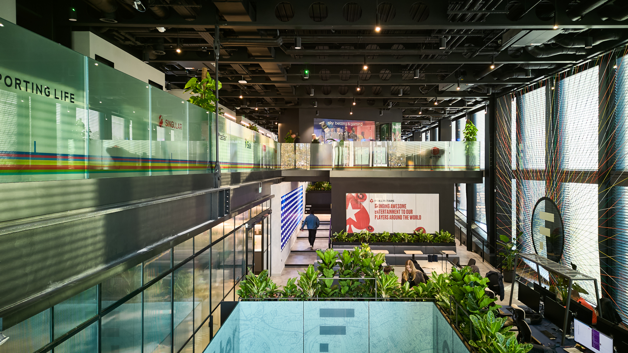 Entertainment Company open plan space with glass walls, branding and adverts screened.