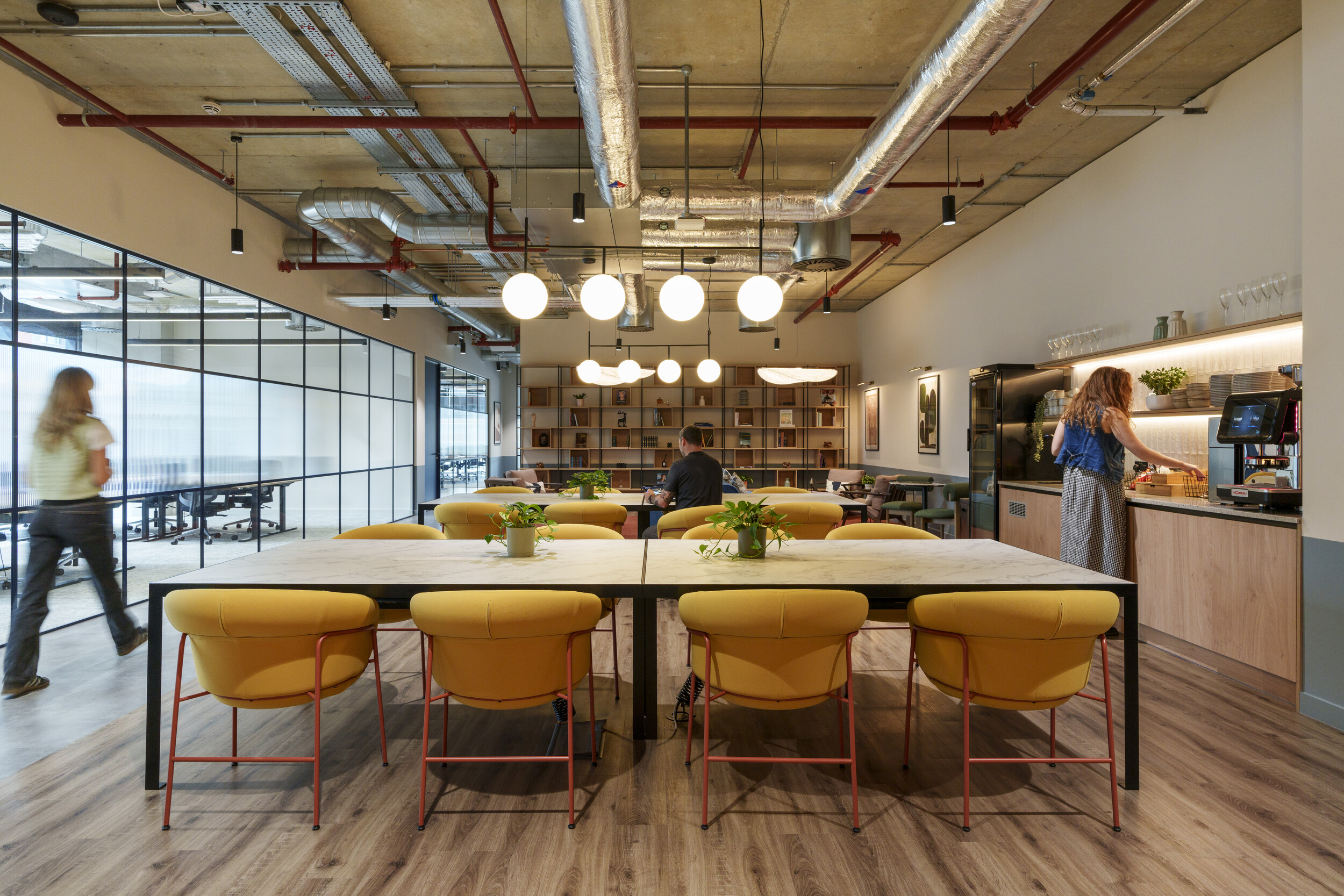 Teapoint at Newflex One Station Hill with yellow chairs, large tables, and modern lighting, blending open-plan seating with a coffee bar and glazing.